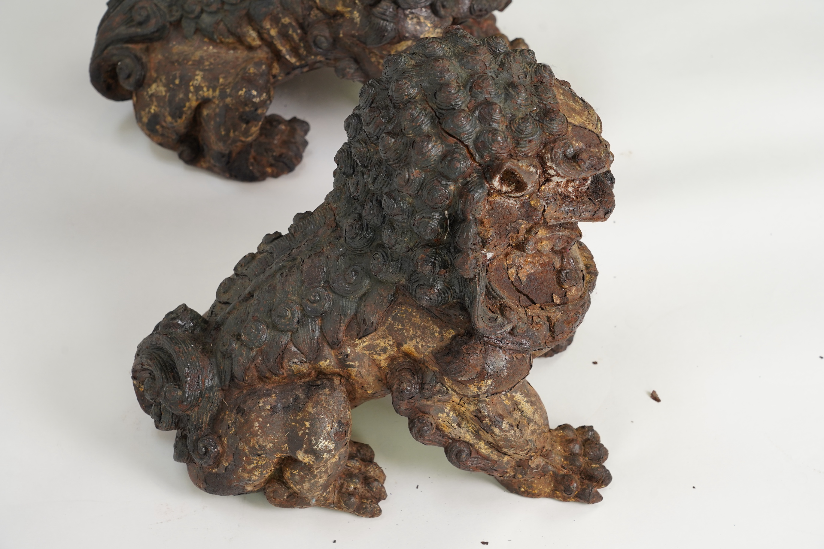 A pair of large Chinese polychrome lacquered cast iron models of lion temple guardians, Qing dynasty